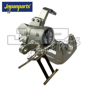 A metallic automotive brake calliper is displayed on a white background with the Japanparts logo in the top left corner. The calliper includes a mounting bracket and detailed mechanical components. | Jap Service Parts - Car Parts