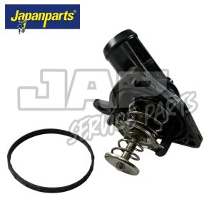 A black automotive thermostat with a spring mechanism and a separate rubber gasket, displayed on a white background with the Japanparts logo in the top left corner. | Jap Service Parts - Car Parts